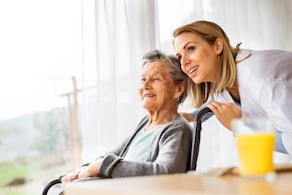 Life Assure Health Visitor And Senior Woman During Home Visit Hero
